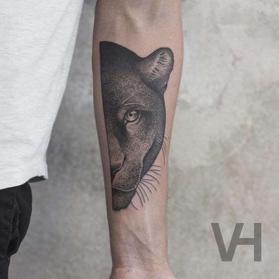 Very detailed forearm tattoo of split black panther head by Valentin Hirsch