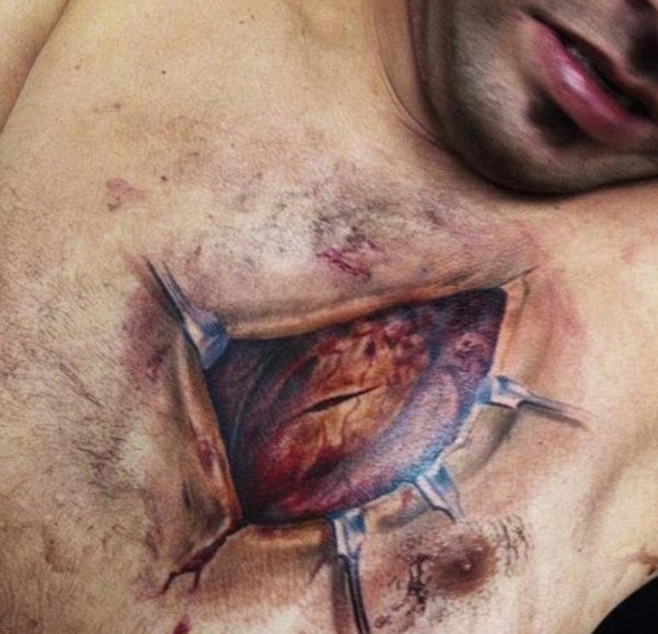 Very detailed natural looking colored ripped skin tattoo on chest with human heart
