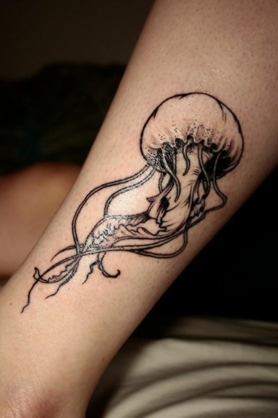 Very realistic 3D like little black ink jelly-fish tattoo on ankle