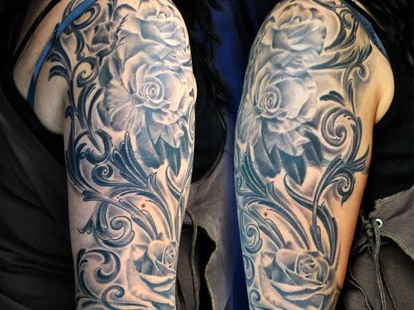 Very realistic black and white big roses arm tattoo