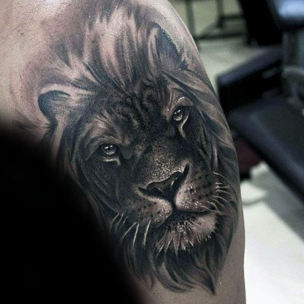 Very realistic black ink shoulder tattoo of lion head