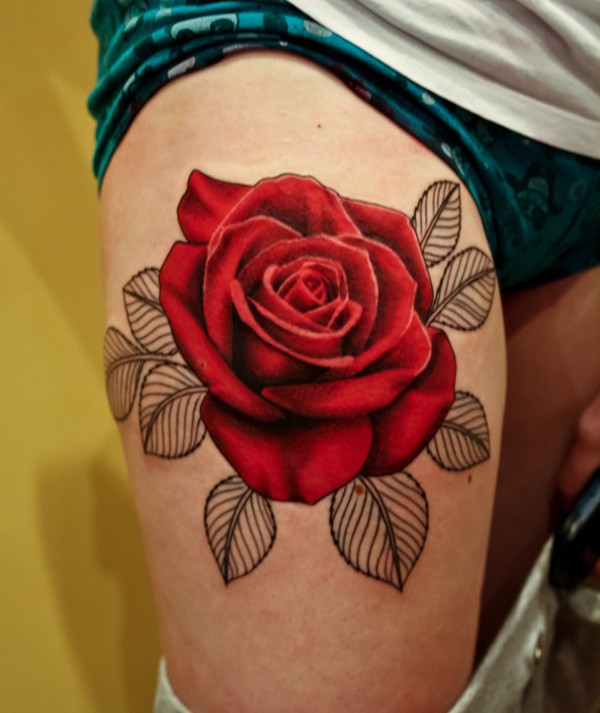 Very realistic colored and detailed big rose tattoo on thigh