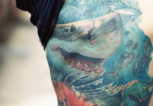 Very realistic looking beautiful colored big shark tattoo on thigh