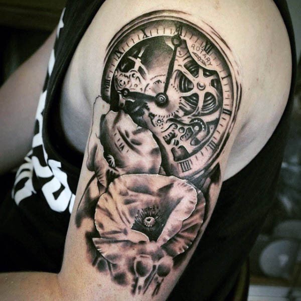 Very realistic looking black and white mechanic clock with flower tattoo on arm