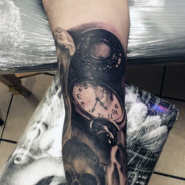 Very realistic looking black and white antic clock tattoo on arm