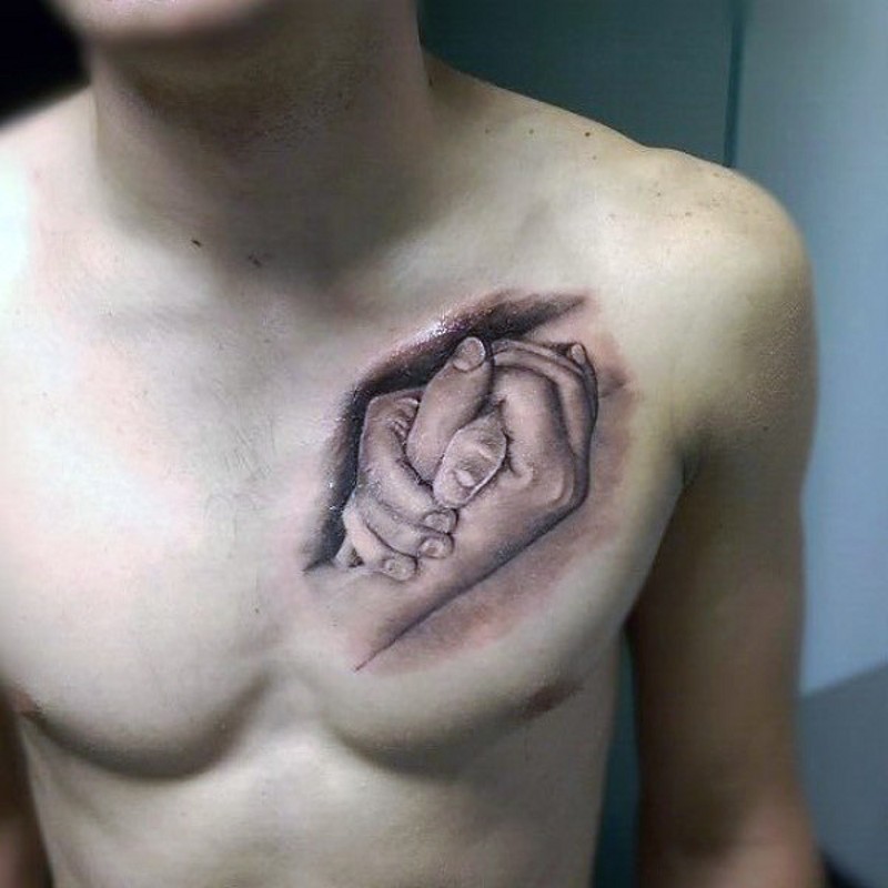 Very realistic looking black and white hands tattoo on chest