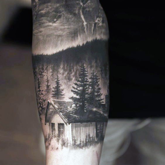 Very realistic looking black and white old forest house tattoo on arm