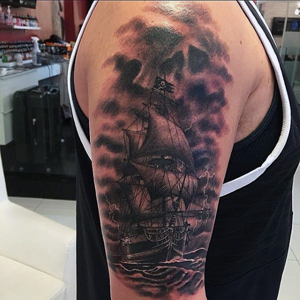 Very realistic looking black ink big old ship tattoo on shoulder