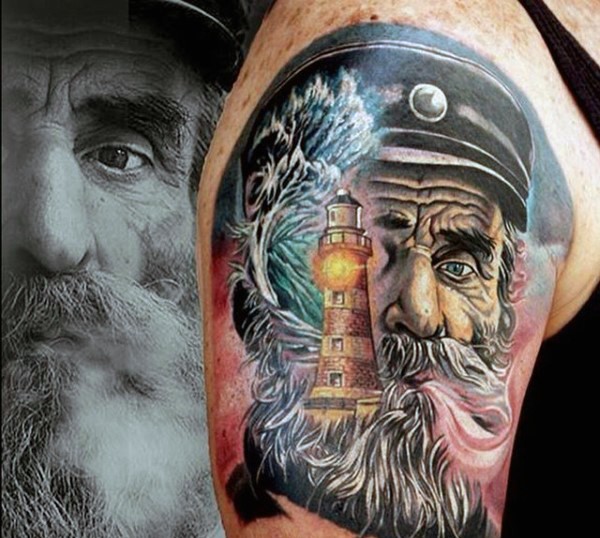 Very realistic looking colored old sailor with lighthouse tattoo on shoulder