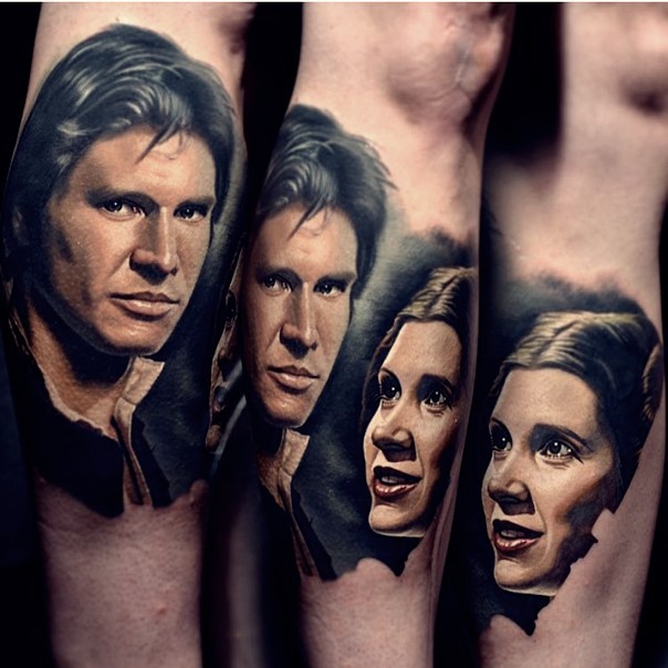 Very realistic looking colored portraits on forearm tattoo of Han Solo and Leia Organa