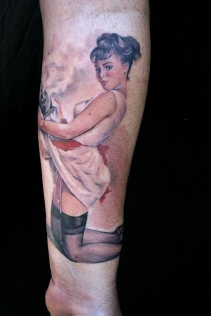 Very realistic looking colored sexy pin up girl tattoo on leg