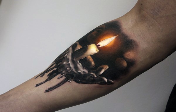 Very realistic looking detailed and colored burning candle tattoo on arm