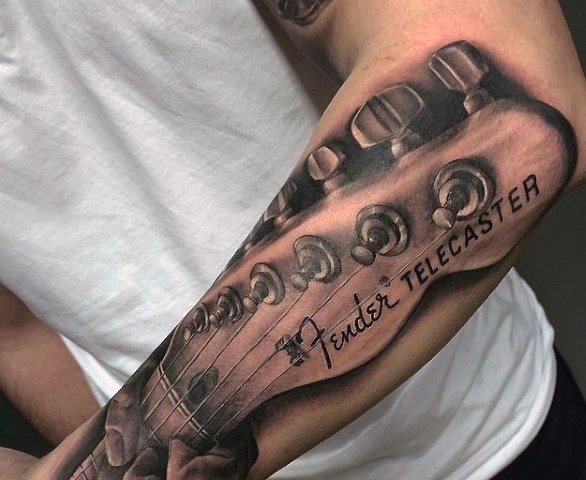 Very realistic looking detailed Fender Telecaster guitar tattoo on arm