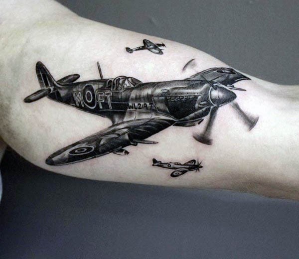 Very realistic looking detailed realism style arm tattoo of WW2 fighter planes