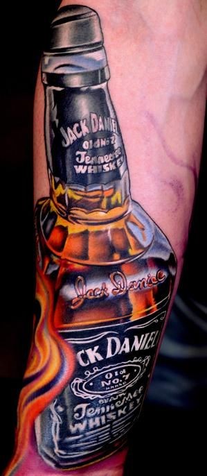 Very realistic looking multicolored Jack Daniels whiskey bottle tattoo on arm