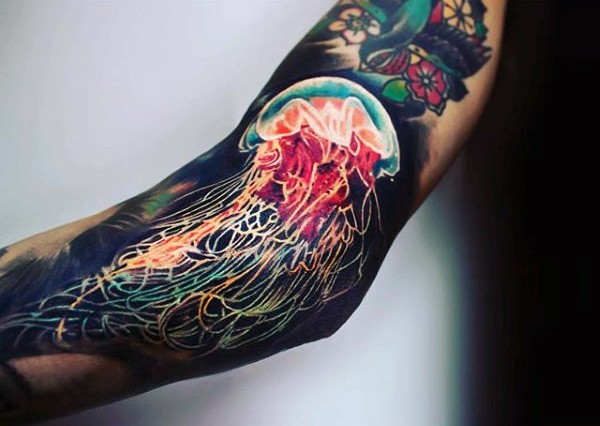 Very realistic looking multicolored jellyfish tattoo on arm