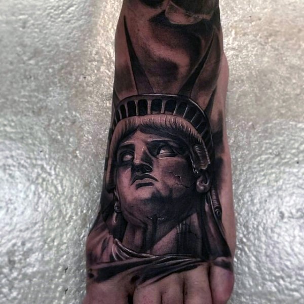 Very realistic looking old corrupted Statue of Liberty tattoo on foot