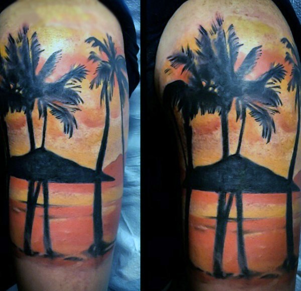 Very romantic looking colored ocean sunset with palm trees shoulder tattoo