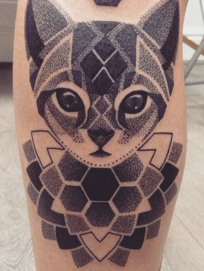 Vintage black ink tribal cat tattoo on leg muscle