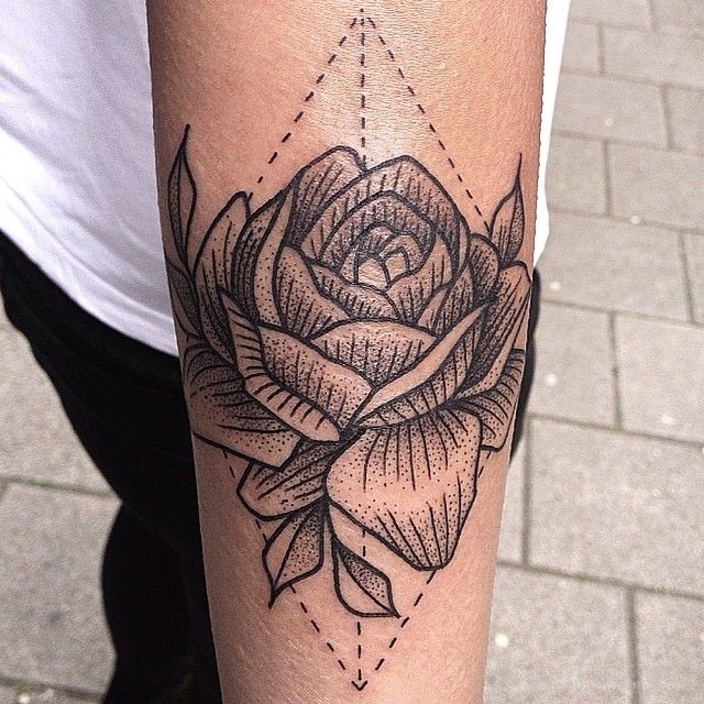 Vintage black ink usual rose tattoo on forearm with geometrical figure