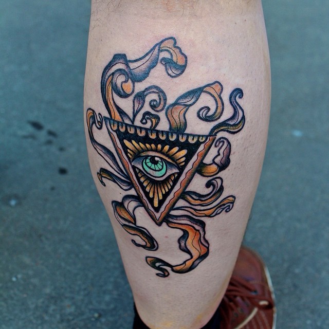 Vintage like colored leg muscle tattoo of mystic triangle with eye