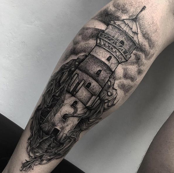 Vintage style black and white old lighthouse tattoo on leg