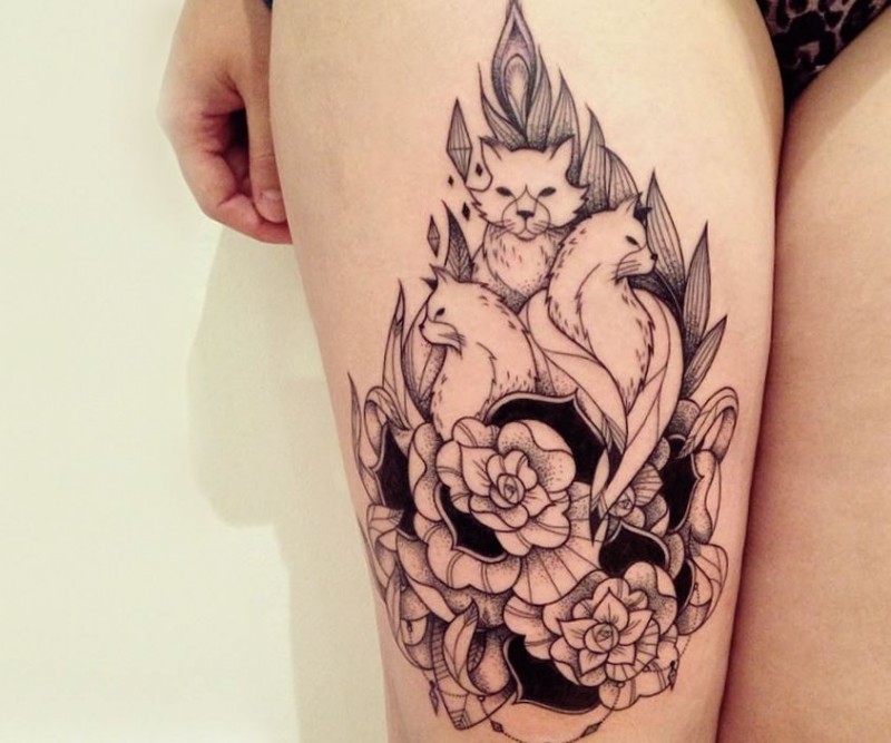 Vintage style black and white thigh tattoo of various cats and flowers