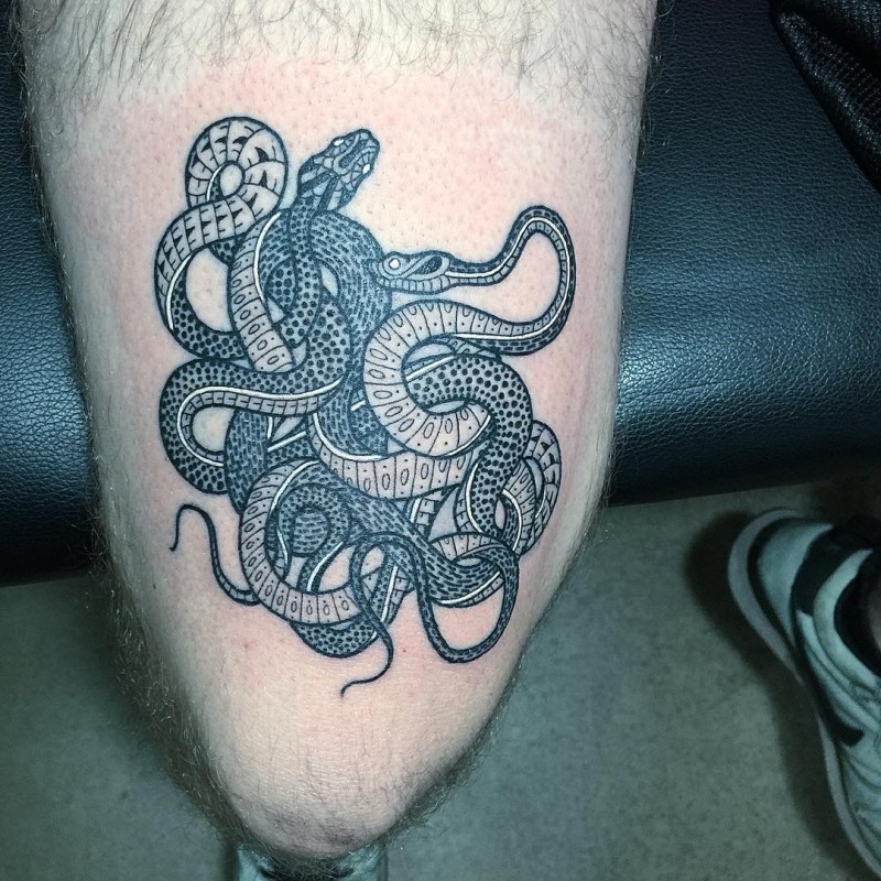 Vintage style black and white thigh tattoo of various snakes