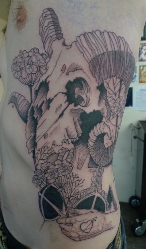 Vintage style black ink side tattoo of woman with flowers and goat skull