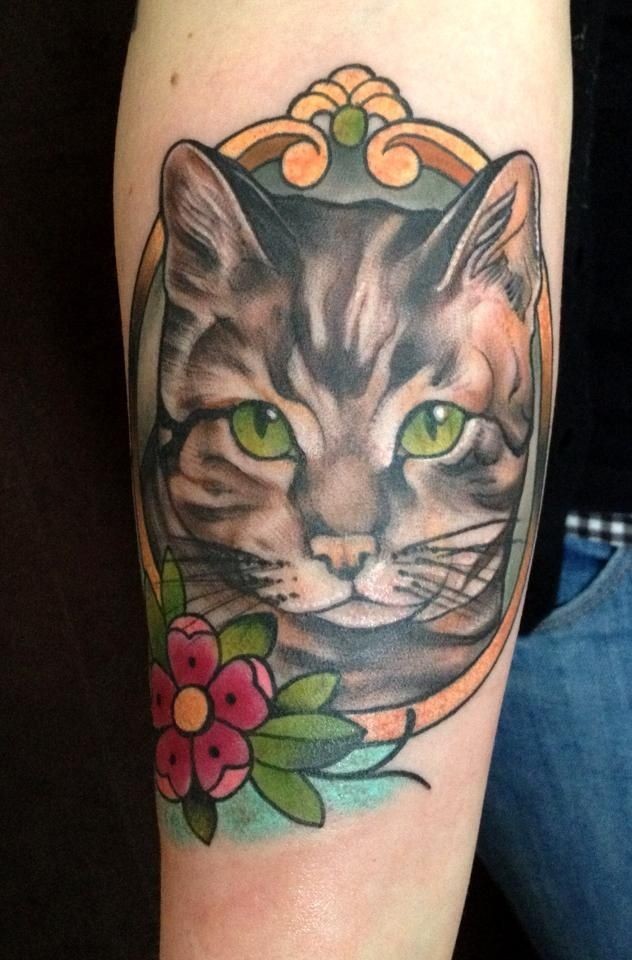 Vintage style colored arm tattoo of impressive cat portrait with flower