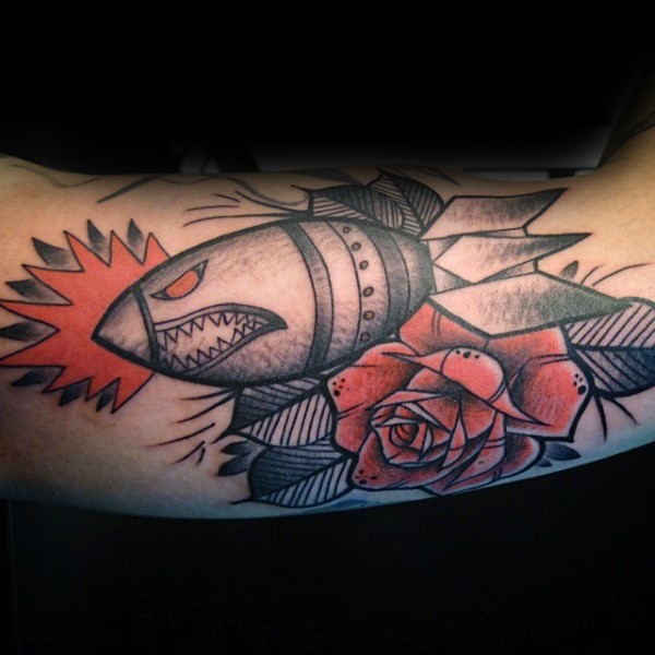 Vintage style colored cool looking bomb with flower tattoo on arm