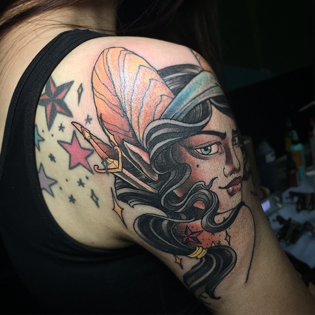 Vintage style colored fantasy woman tattoo on shoulder stylized with sword and stars