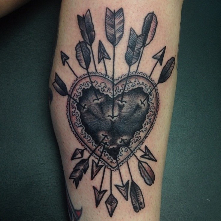 Vintage style colored human heart with arrows tattoo
