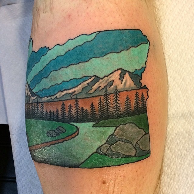 Vintage style multicolored leg muscle tattoo of mountain river and forest