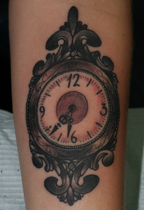 Vintage style multicolored old clock tattoo on forearm