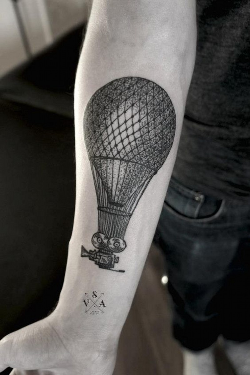 Vintage style painted big balloon with camera tattoo on arm