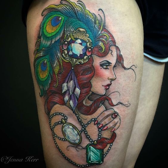 Vintage style painted by Jenna Kerr colored thigh tattoo of seductive woman portrait combined with jewelry and peacock feather