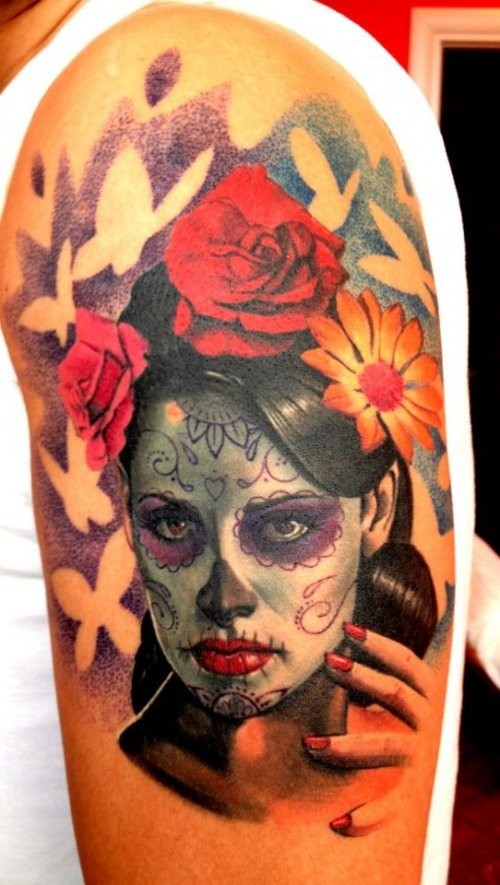 Vivid colors adorable santa muerte with flowers in black haired tattoo on shoulder
