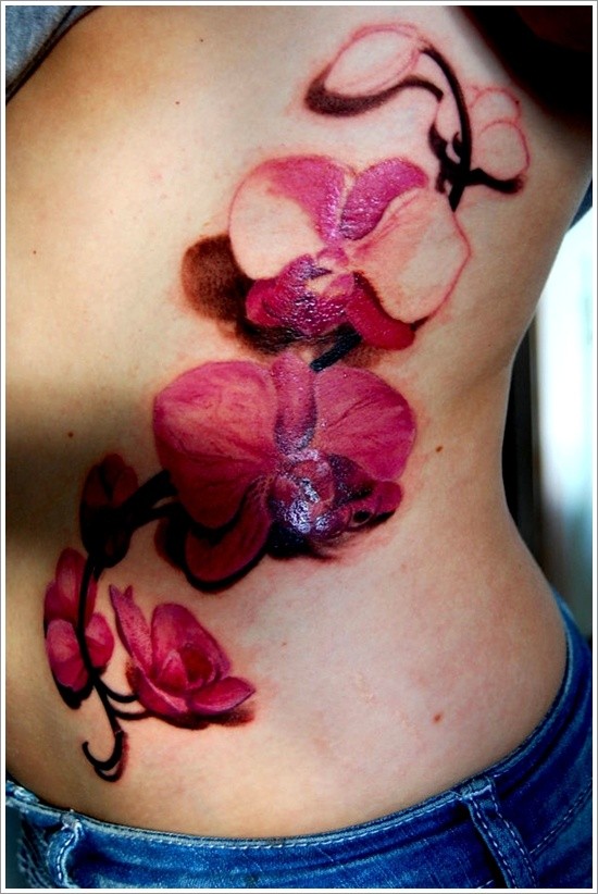 Vivid colors orchids tattoo on ribs