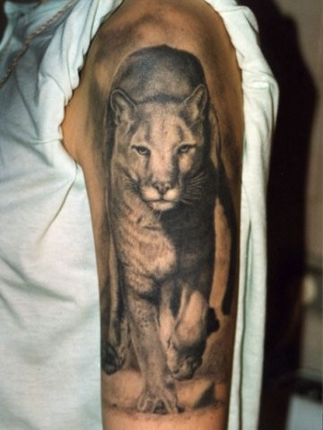 Walking lioness tattoo on half sleeve