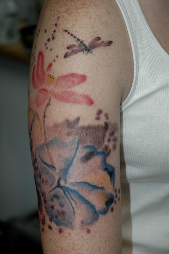 Watercolor flowers with dragonfly tattoo on arm