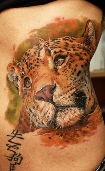 Watercolor leopard head tattoo on ribs by Dmitriy Samohin