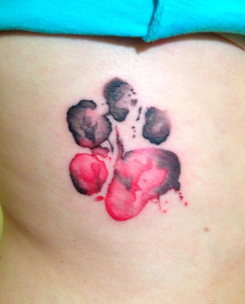 Watercolor like painted little animal print tattoo on back