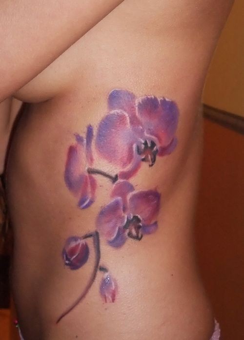 Watercolor lovely orchids tattoo on ribs