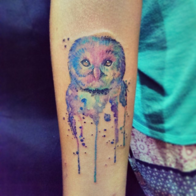 Watercolor owl tattoo on arm