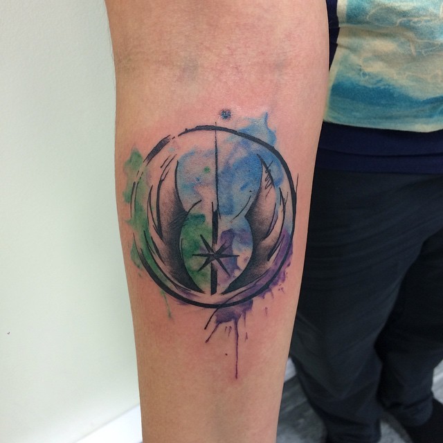 Watercolor style amazing looking Star Wars emblem tattoo on forearm