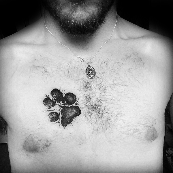 Watercolor style black ink chest tattoo of dog paw print