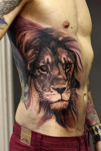 Watercolor style colored belly tattoo of lion head