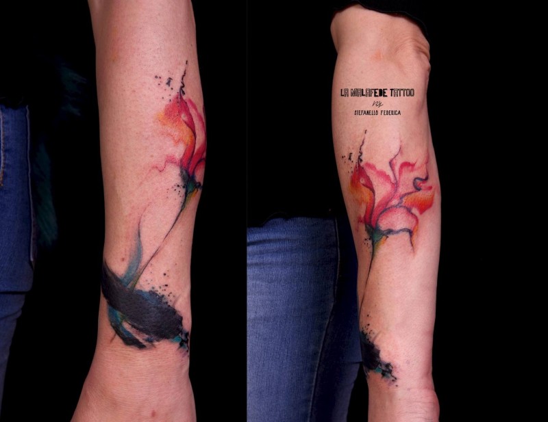 Watercolor style colored forearm tattoo of big flower