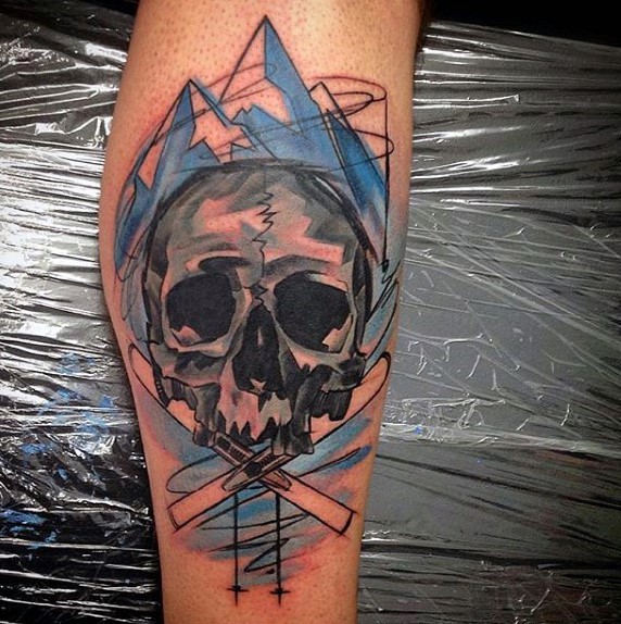 Watercolor style colored human skull with mountains tattoo on leg